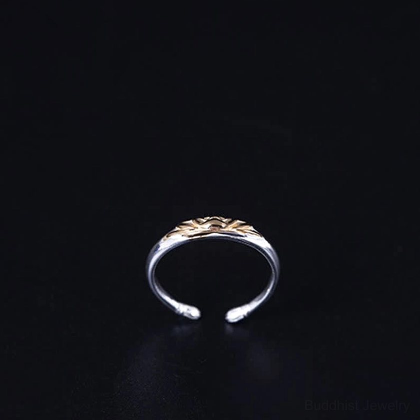 Sterling silver lotus ring front view with gold lotus top decoration and polished slim silver band finish