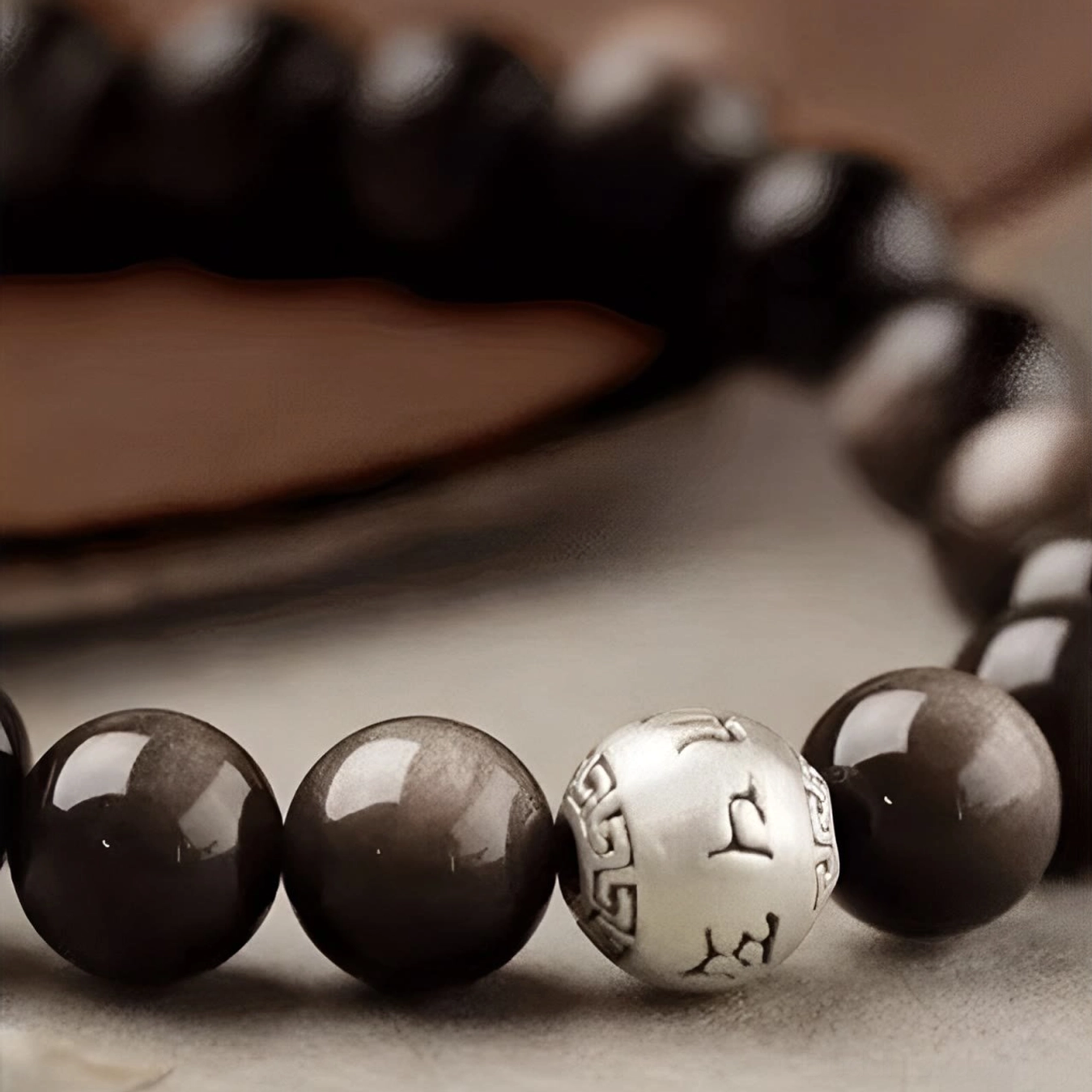Handmade Silver Sheen Obsidian Om Mani Padme Hum bracelet collection showing multiple bead sizes and versatile spiritual styling