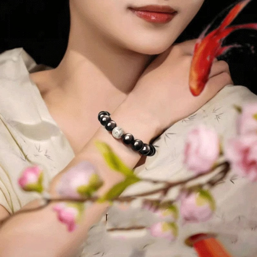 Wrist styling of Silver Sheen Obsidian Buddhist bracelet with Om Mani Padme Hum mantra charm in everyday wear scenario