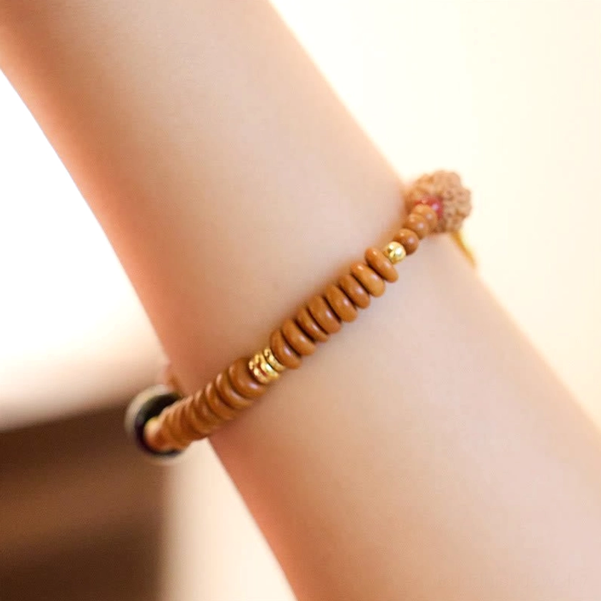 Minimalist Bodhi seed beaded bracelet with single black accent bead worn on wrist