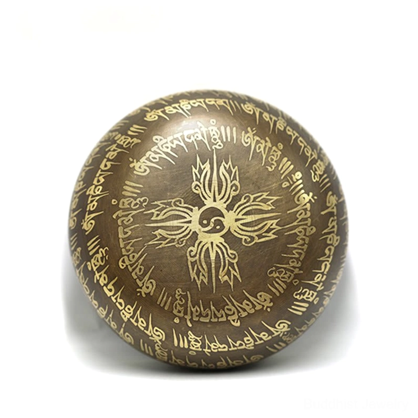 Top-down view of upside-down Buddhist singing bowl showing Vajra pattern and surrounding sacred mantras