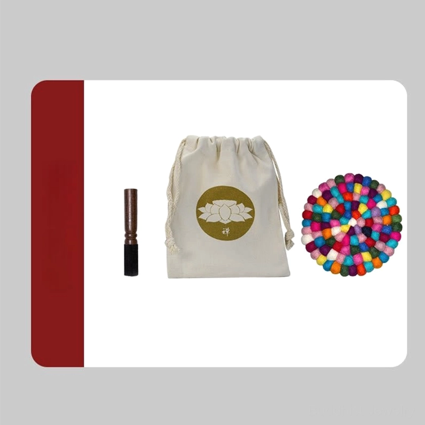 Complete singing bowl meditation set including drawstring bag, wooden mallet, decorative beads, and lotus logo