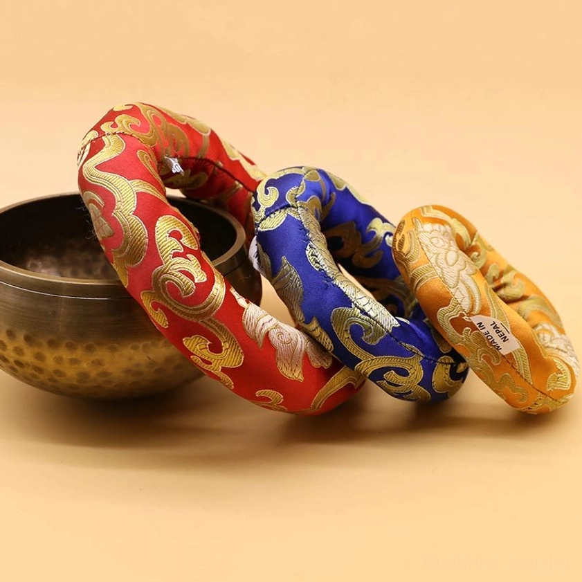 Buddhist singing bowl meditation cushions displayed with metal singing bowl for size comparison, showing handmade brocade textile design