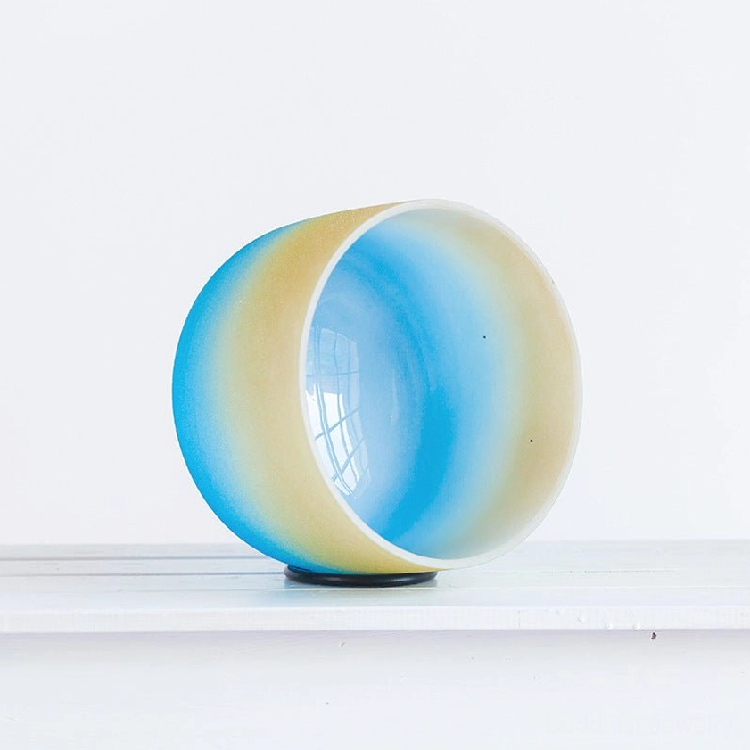 Crystal singing bowl interior view displaying smooth cavity and blue gradient finish for sound resonance