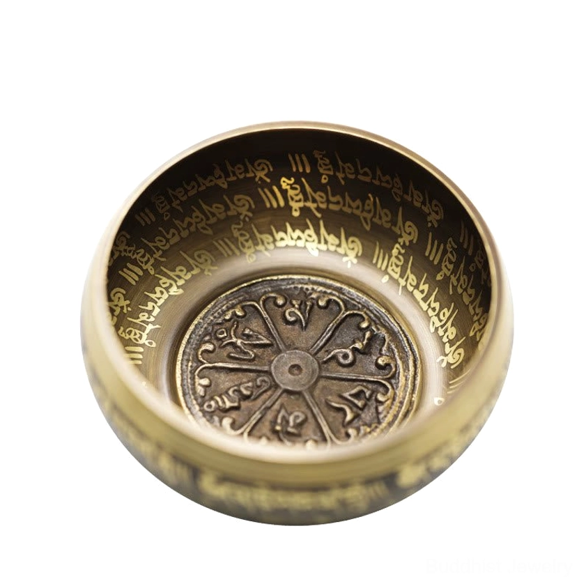 Close-up interior view of Buddhist singing bowl showing engraved Vajra pattern and sacred mantras