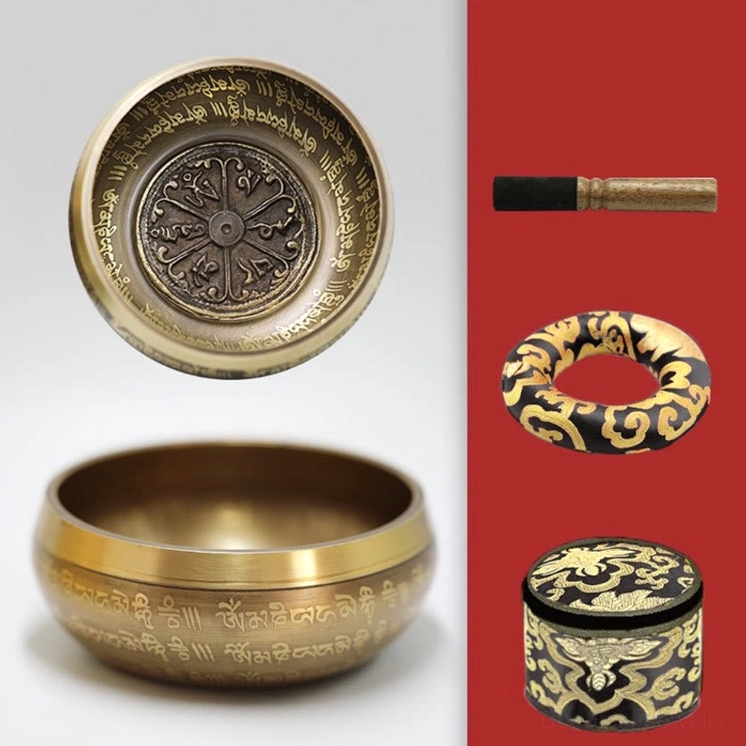 Flat lay of singing bowl meditation set with bowl, wooden mallet, anti-slip ring and storage case