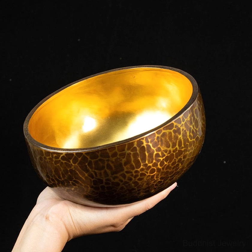 Copper singing bowl side rim view dark background studio shot showing bronze exterior craftsmanship