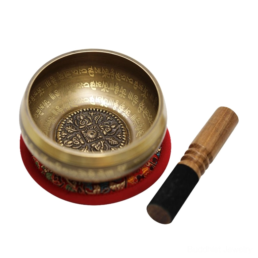 Buddhist singing bowl with wooden mallet and embroidered cushion set up for sound bath meditation and energy healing session