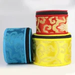 Multi-color singing bowl storage bags with gold brocade embroidery and zipper closure, flat lay view