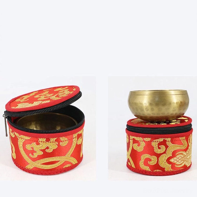 Singing bowl storage demonstration with open bag and brass bowl on white background