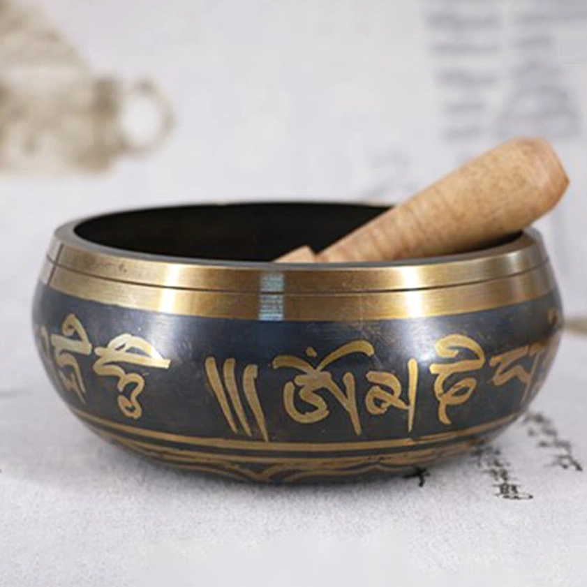 Wooden mallet striker for Buddhist singing bowl with detailed carving, designed for optimal tone production and meditation practice