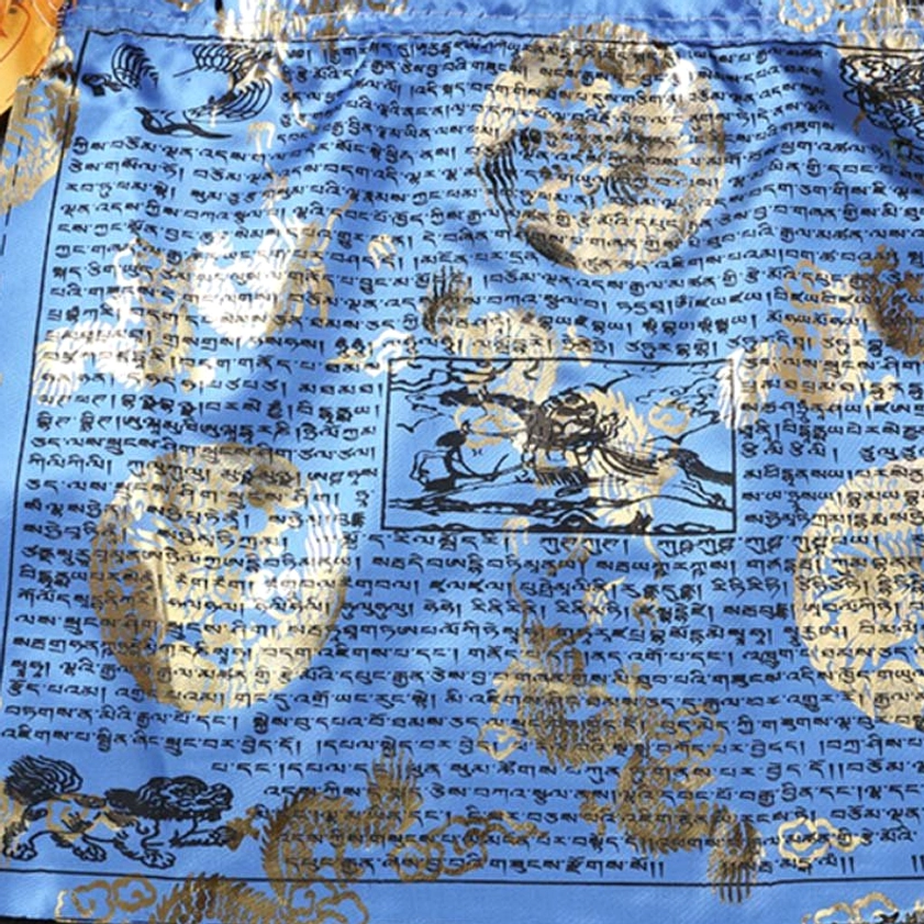 Single blue Buddhist prayer flag with gold foil dragon and windhorse designs and Tibetan script