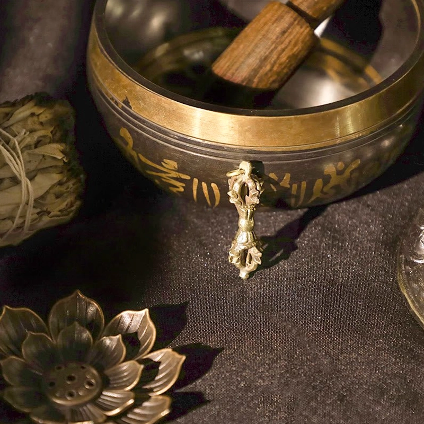 Single dorje with mantra-engraved singing bowl in spiritual ritual display arrangement, brass finish copper vajra dorje