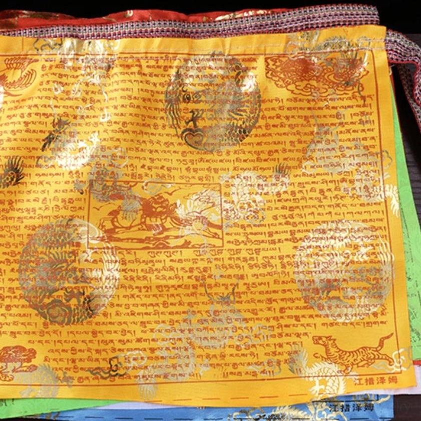 Single yellow Buddhist prayer flag with gold foil dragon and sacred animal patterns with Tibetan script