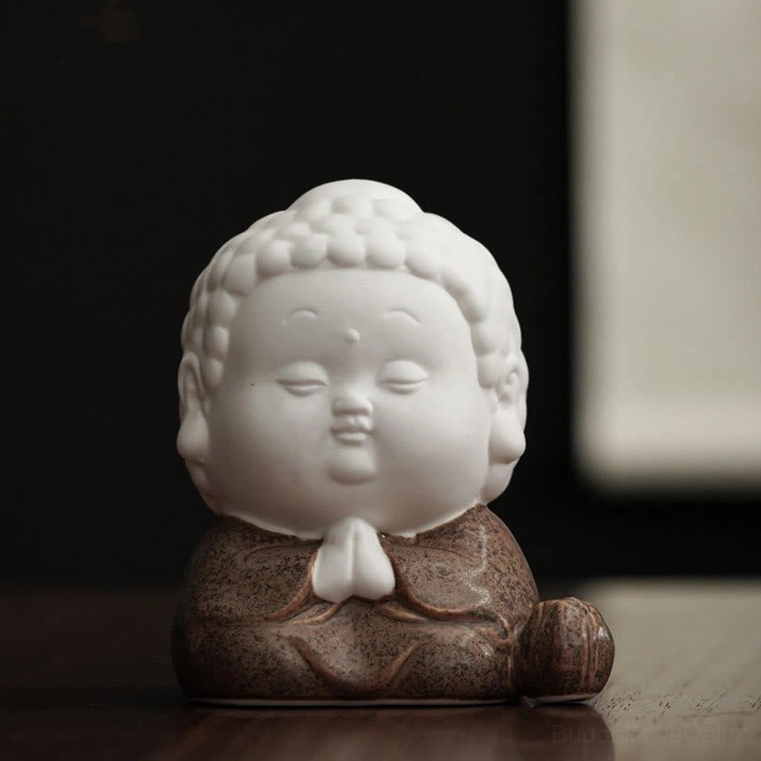 Sitting Buddha meditation incense burner with white ceramic body and celadon glazed robes - centered product display