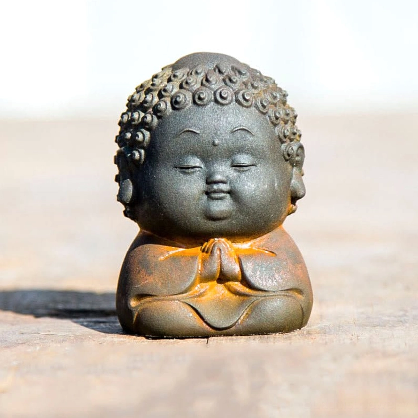 Sitting Buddha statue 6.5x4.6cm size in contemplative meditative pose on wooden surface