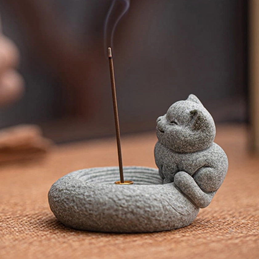 Curled sitting cat stone incense burner with lit incense close-up detail view