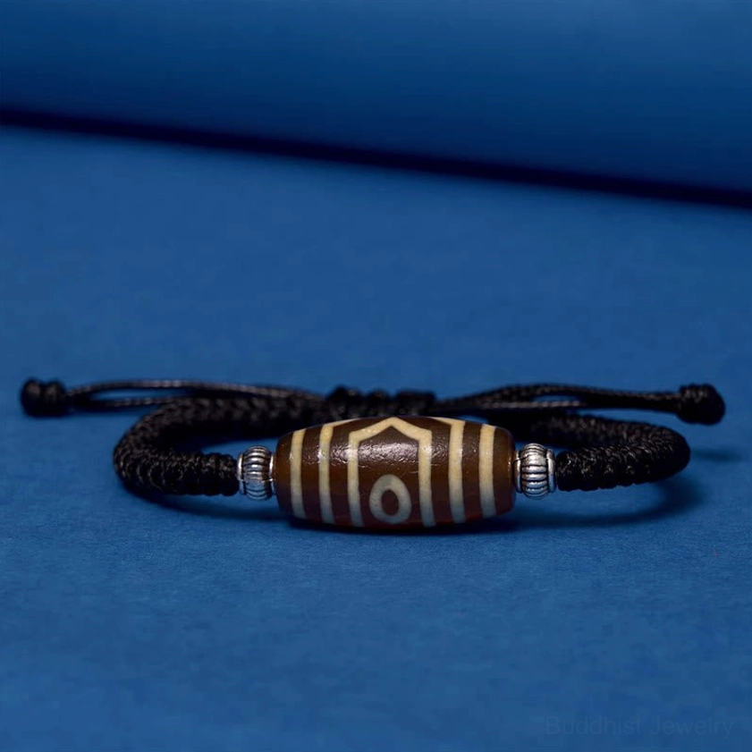 Six-eye dzi bead bracelet worn on human wrist showing comfortable fit and real-world styling