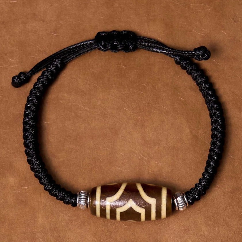 Six-eye dzi bead bracelet overhead perspective showing six-eye pattern and complete circular arrangement