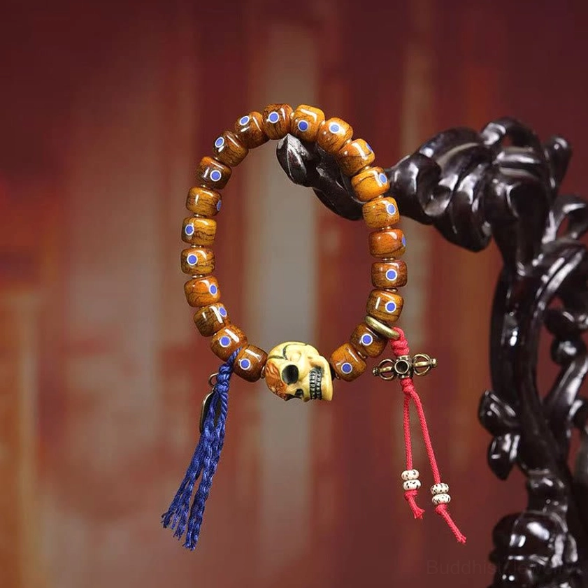 Tibetan-inspired bone skull bracelet on dark wooden background highlighting spiritual protection symbolism