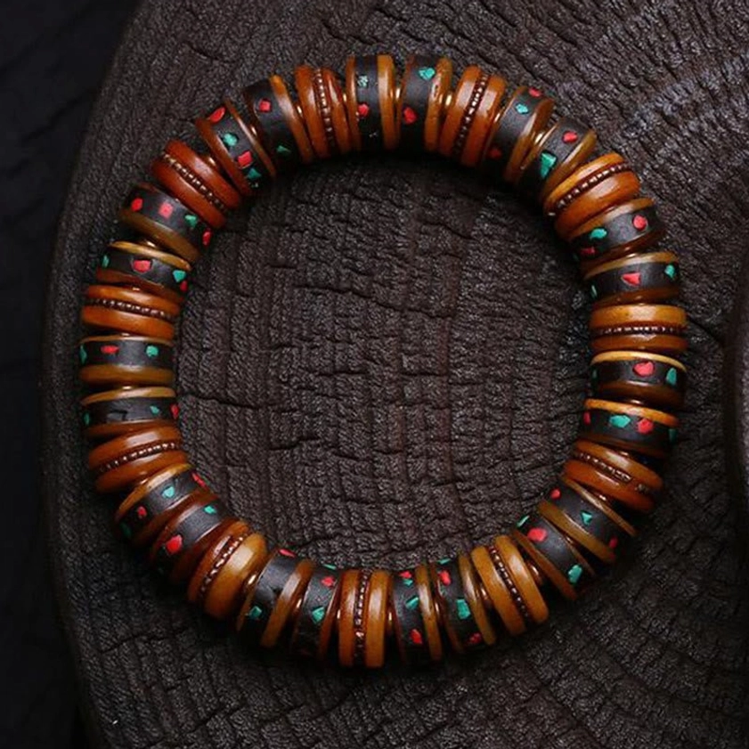 Skull charm variant Buddhist bone bead bracelet with decorative skull charm and multicolor accents for spiritual practice