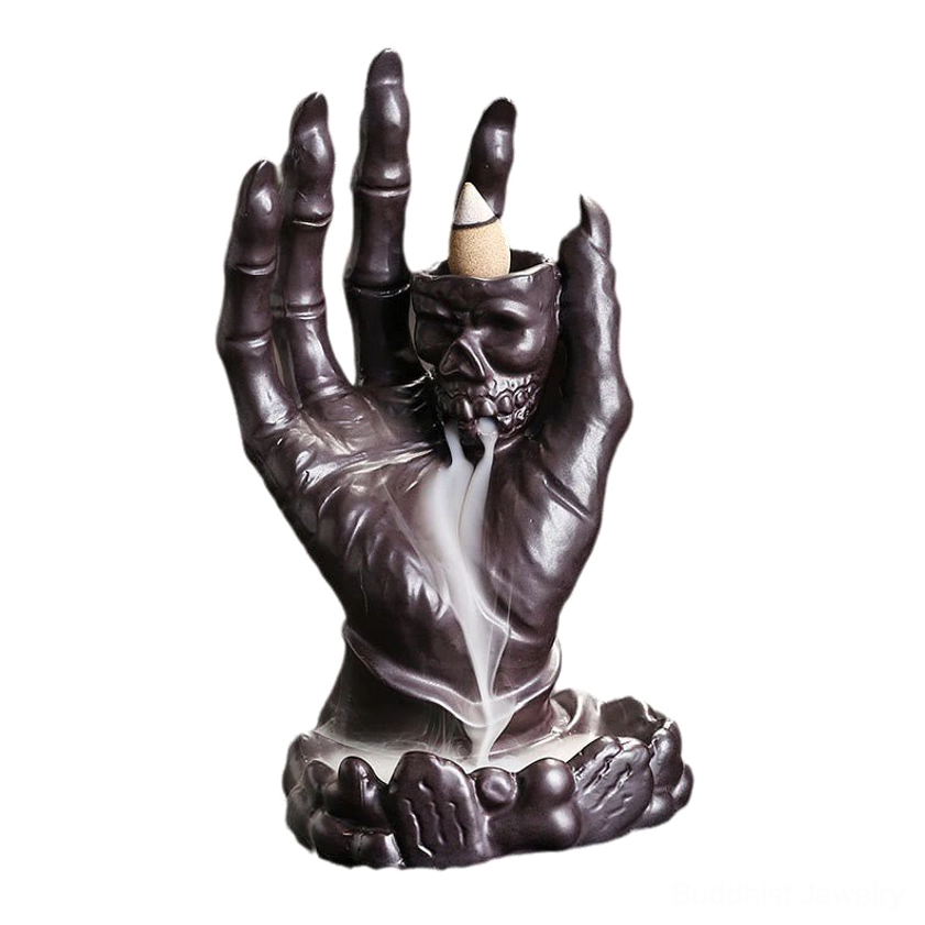 Handcrafted ceramic skull hand incense burner with lotus base isolated on white background
