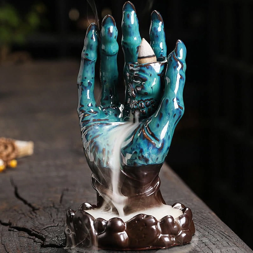 Dark brown and teal blue ceramic skull hand backflow incense burner with mesmerizing smoke flow
