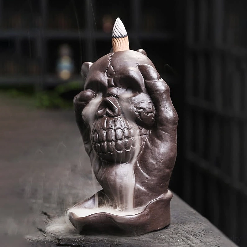 Left side view of handcrafted purple clay skull incense burner with flowing incense smoke effect