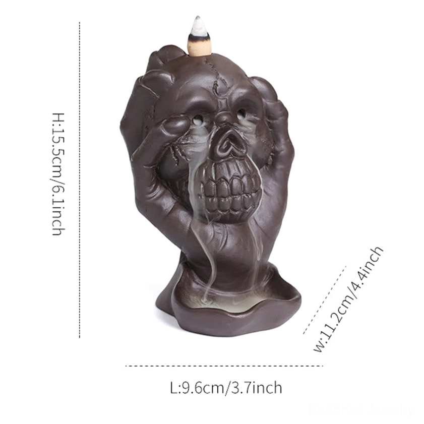 Purple clay skull backflow incense burner with ghost hand - meditation room setting and spiritual ambiance