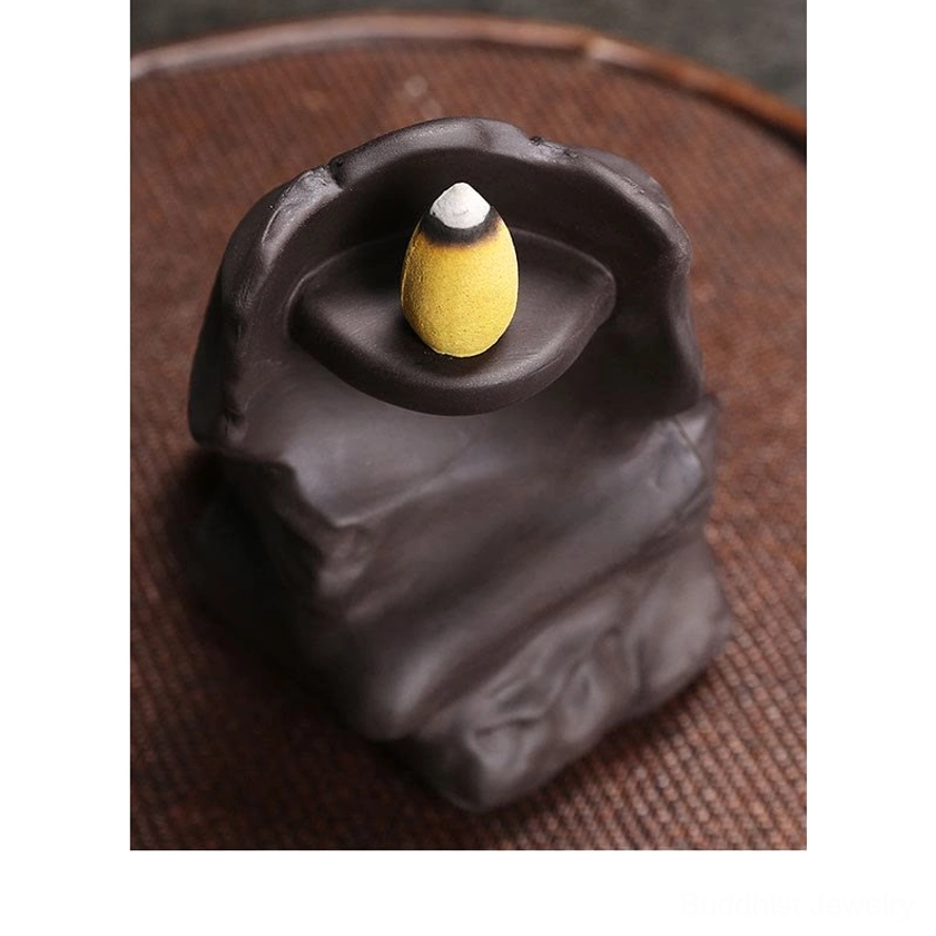 Top-down view of skull incense burner showing rear design and cone incense placement on tray