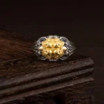925 sterling silver skull protection ring front view with gold embossed detail on wooden display