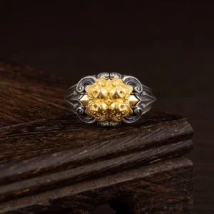 925 sterling silver skull protection ring front view with gold embossed detail on wooden display