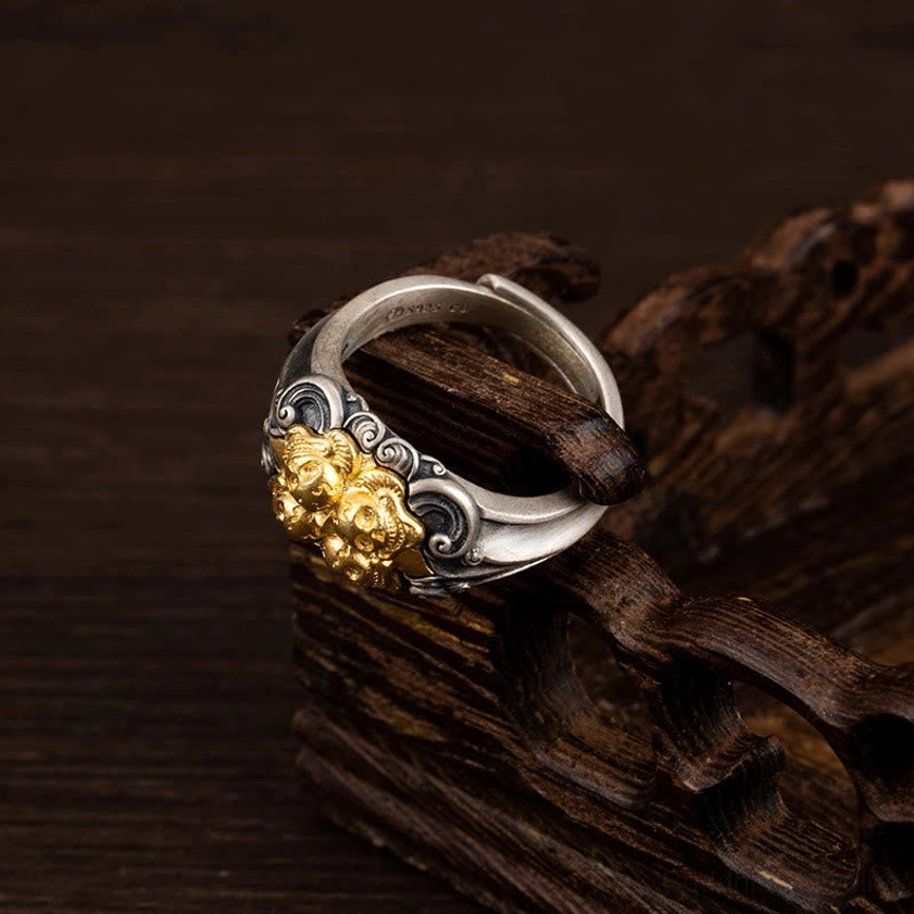 Traditional spiritual skull ring side profile showcasing gilded beast head motif and aged silver finish