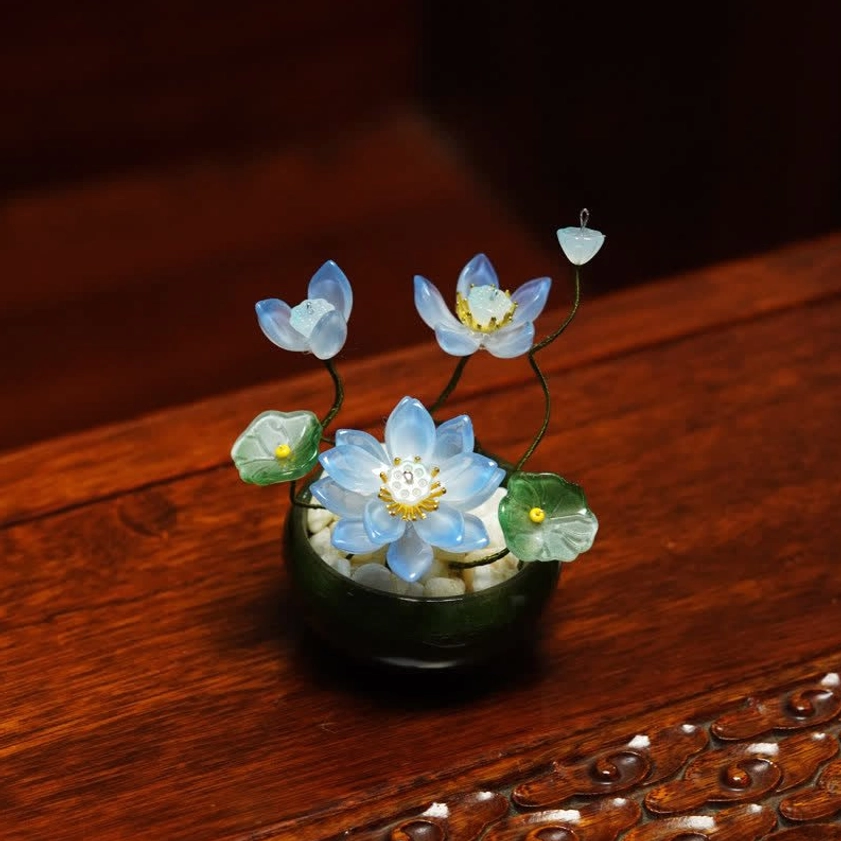 Sky blue liuli lotus flower pot with glass leaves black ceramic pot front view mindful living