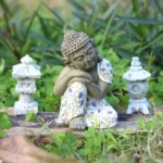Small sleeping Buddha resin statue in peaceful resting pose with detailed mosaic robe, ideal for meditation and home decor