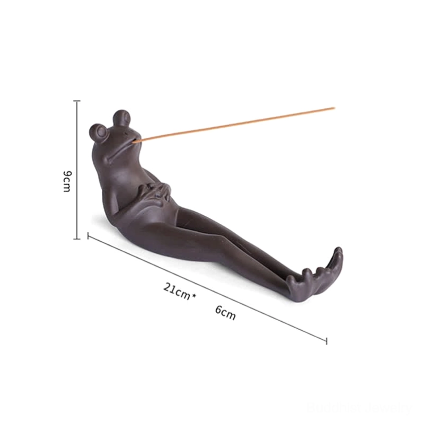 Sleeping frog ceramic incense burner style, relaxed reclining pose in natural light