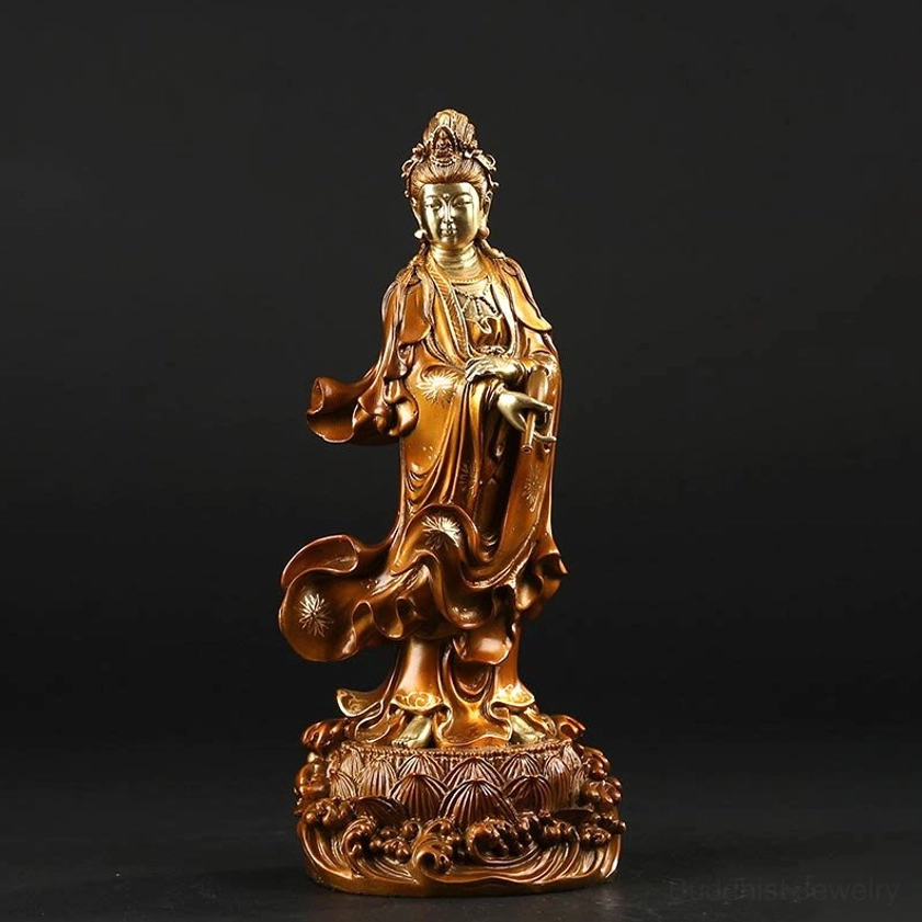 Single small Avalokitesvara brass statue with ornate wave lotus base, front three-quarter view showcasing detailed robes and sacred vase