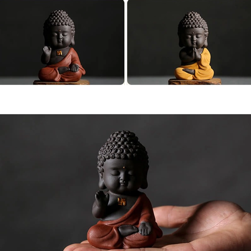 Small Buddha statue with matte finish purple clay, peaceful expression and crossed-leg meditation pose for spiritual practice