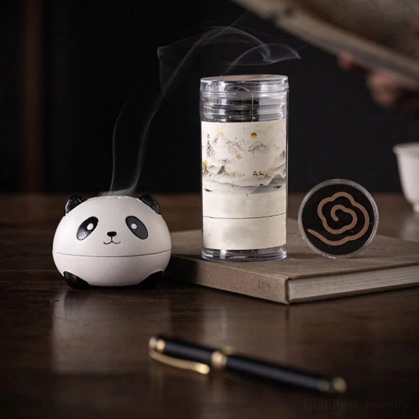 Mini panda ceramic incense burner in study desk setting, paired with incense supplies and burning incense