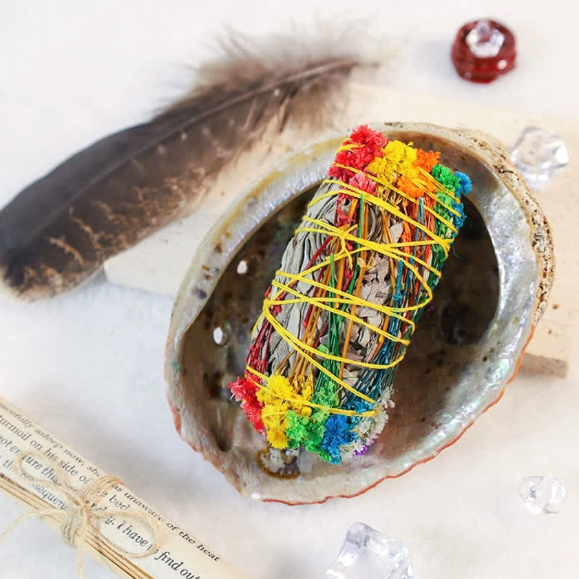 Sacred smudge stick bundle collection showing vibrant dried flowers and natural materials