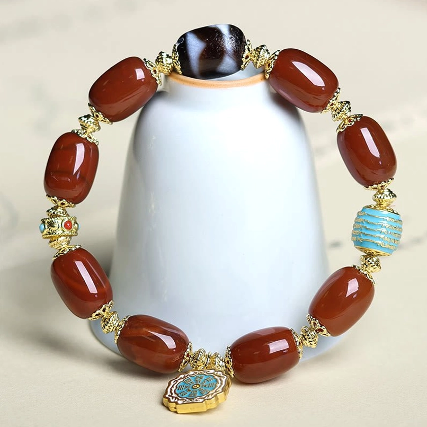 South Red Agate Bagua Dzi Bead Bracelet displayed on white ceramic stand - product showcase with turquoise spacer and Bagua charm