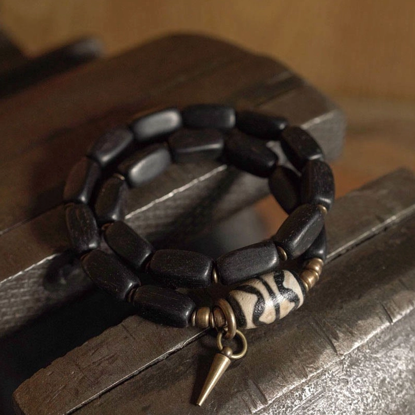 Close-up elevated view of spiked ebony dzi bracelet with tiger stripe bead pattern