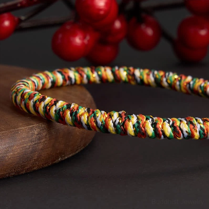 Spiritual balance bracelet handwoven with multicolor cord, copper charm, and Buddhist lotus symbolism