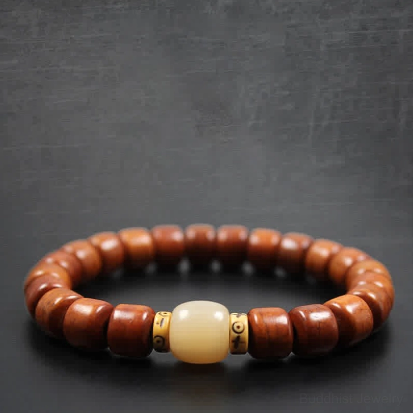 Spiritual bone beads bracelet with reddish-brown barrel beads and light center accent on gray background