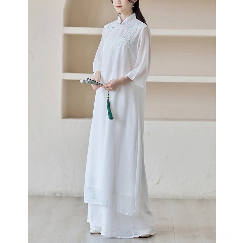 Zen meditation spiritual practice set featuring cheongsam dress with wide leg pants, full-body front view with model holding small folding fan and green tassel pendant