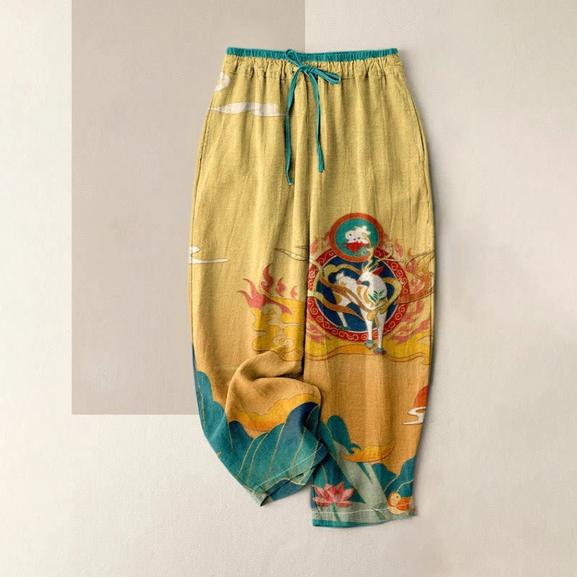Ethnic spiritual printed harem pants in multi-color gradient showing deer and lotus symbols, relaxed wide-leg silhouette