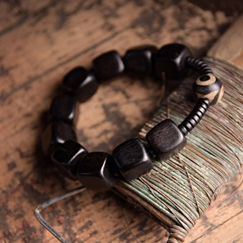 Spiritual protection bracelet with ebony wood and nine-eye dzi bead, vintage thread spool styling