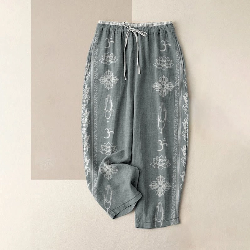 Women's cadet blue spiritual harem pants with sacred Buddhist symbols, flat lay front view
