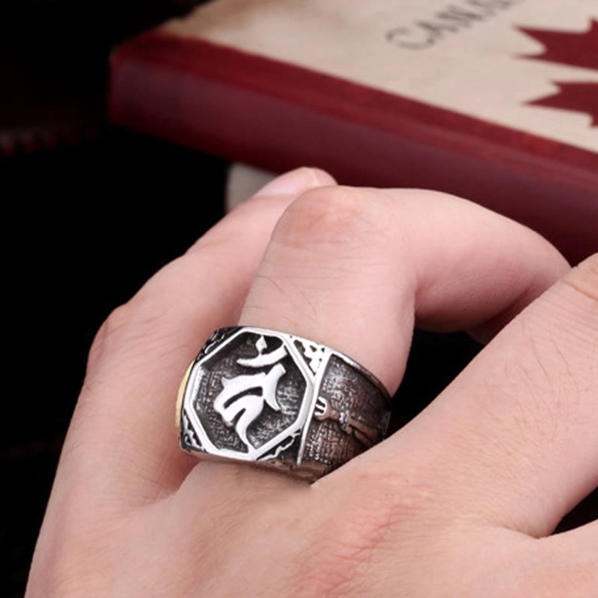 Buddhist Sanskrit ring worn on middle finger showing real-life styling and dual-tone design