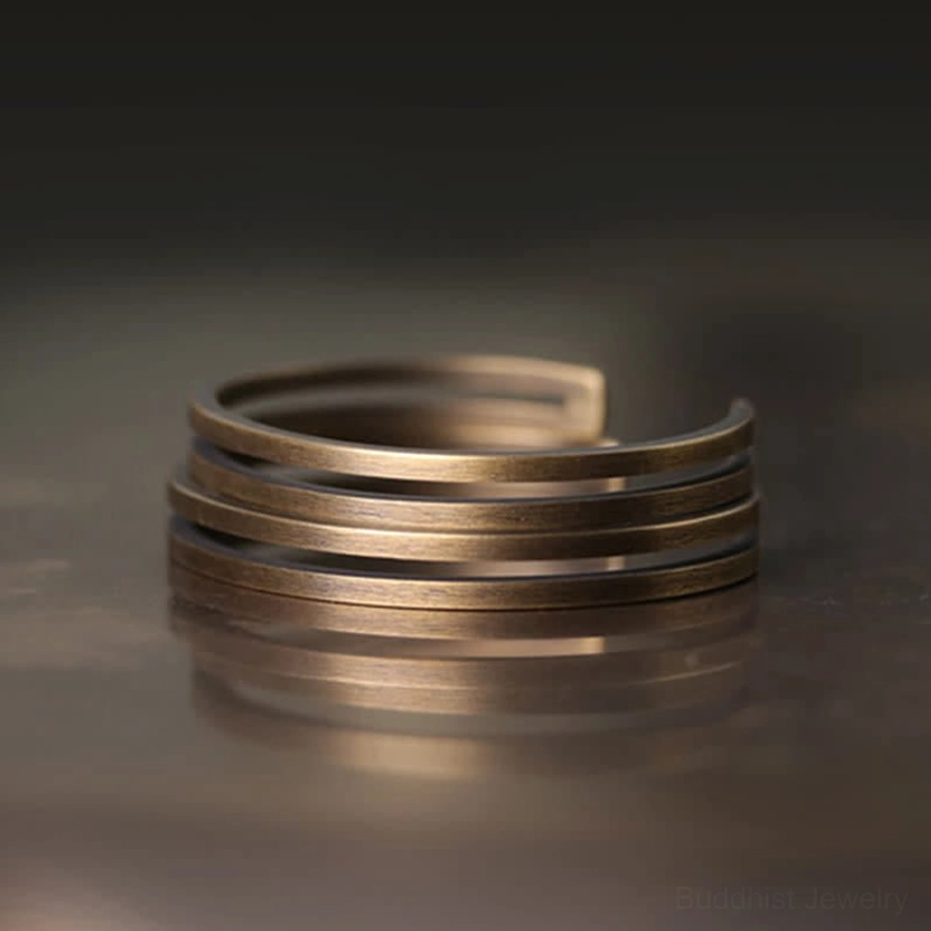 Stacked multiple antique bronze copper cuff bracelets layered together for spiritual amplification
